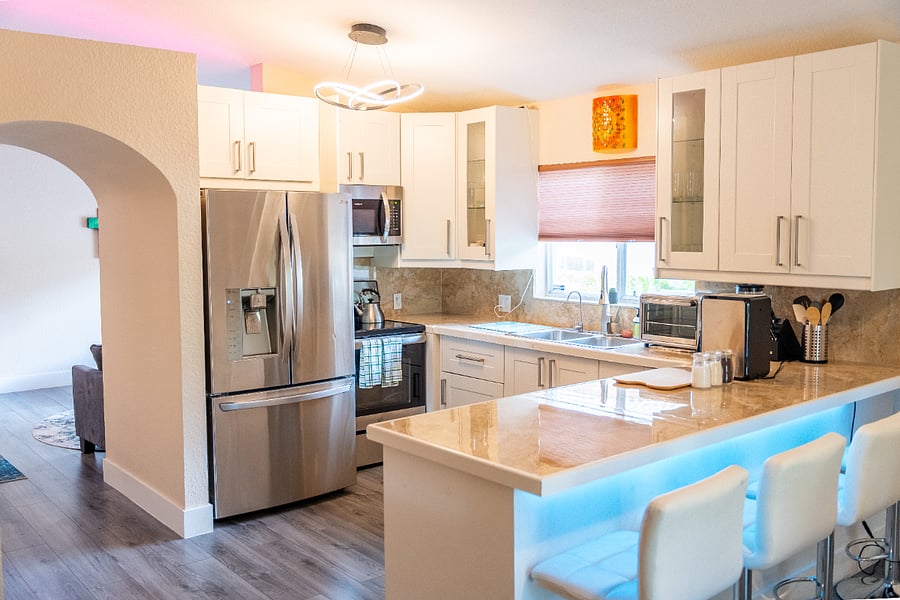 Fully equipped kitchen with cookware, plates, and silverware