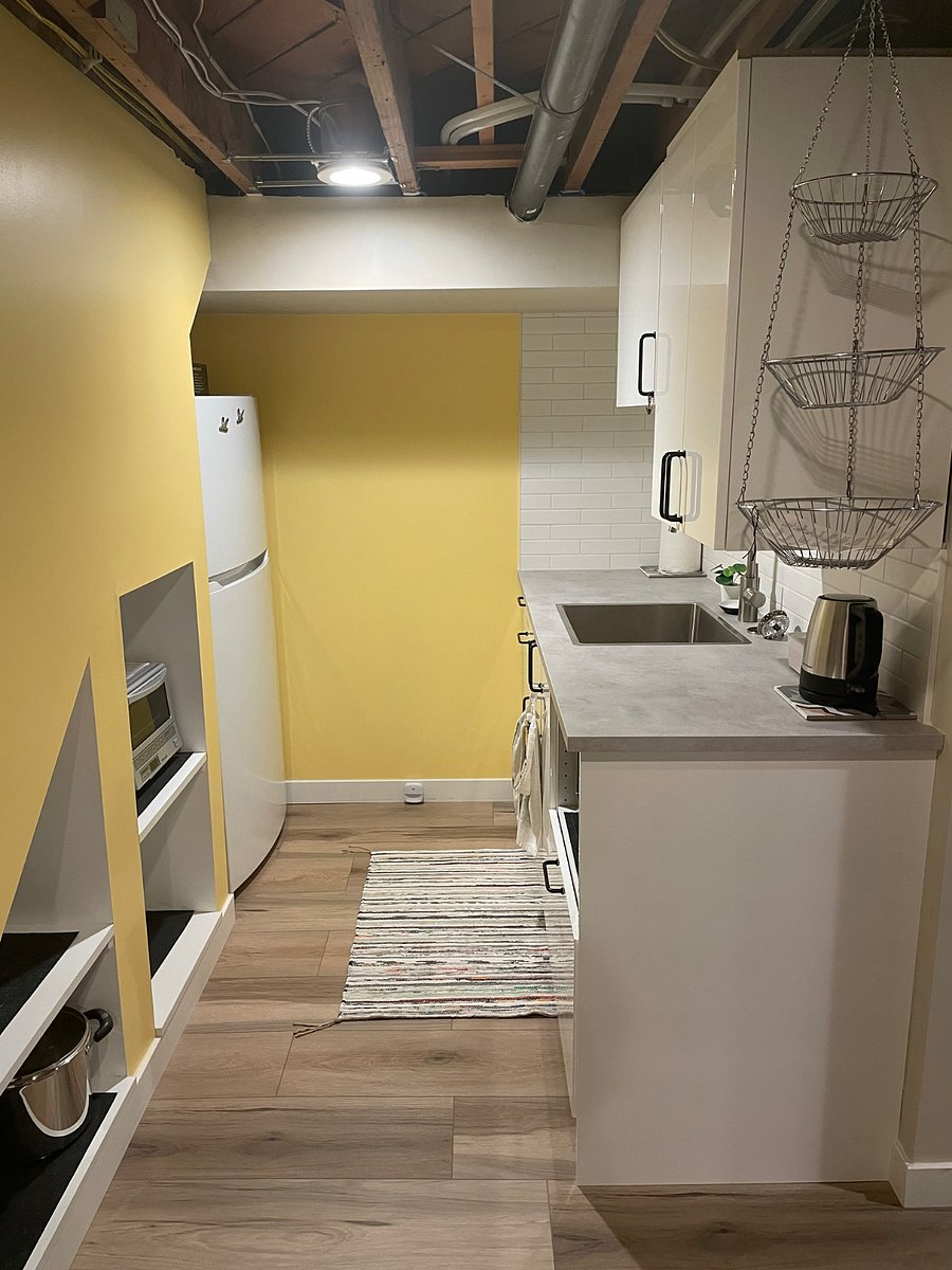 Kitchenette w/ full size fridge/freezer, small appliances (microwave, single  induction burner, toaster oven, Keurig, kettle, dishes, utensils & kitchen essentials). There is no full-sized oven, kitchen hood, or dishwasher. 