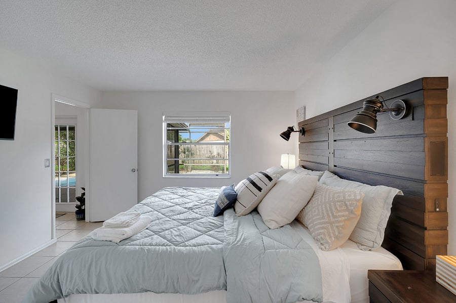 King bed with en suite, walk-in closet, 43" smart TV, Bluetooth speaker, walk-in shower with rainwater head, and new blackout curtains.