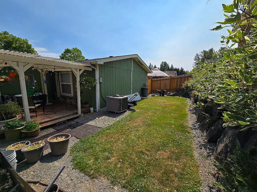Fully fenced backyard with deck
