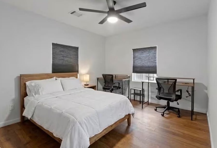 Bedroom 3 is equipped with a queen bed and workspace.