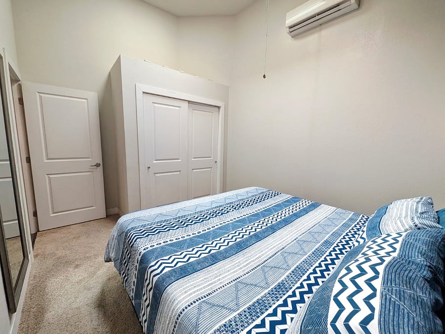 Spacious king-size bed with plush bedding, inviting a comfortable nights sleep
