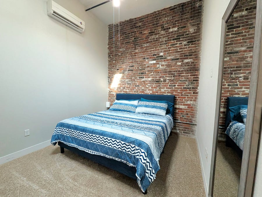 Spacious king-size bed with plush bedding, inviting a comfortable nights sleep