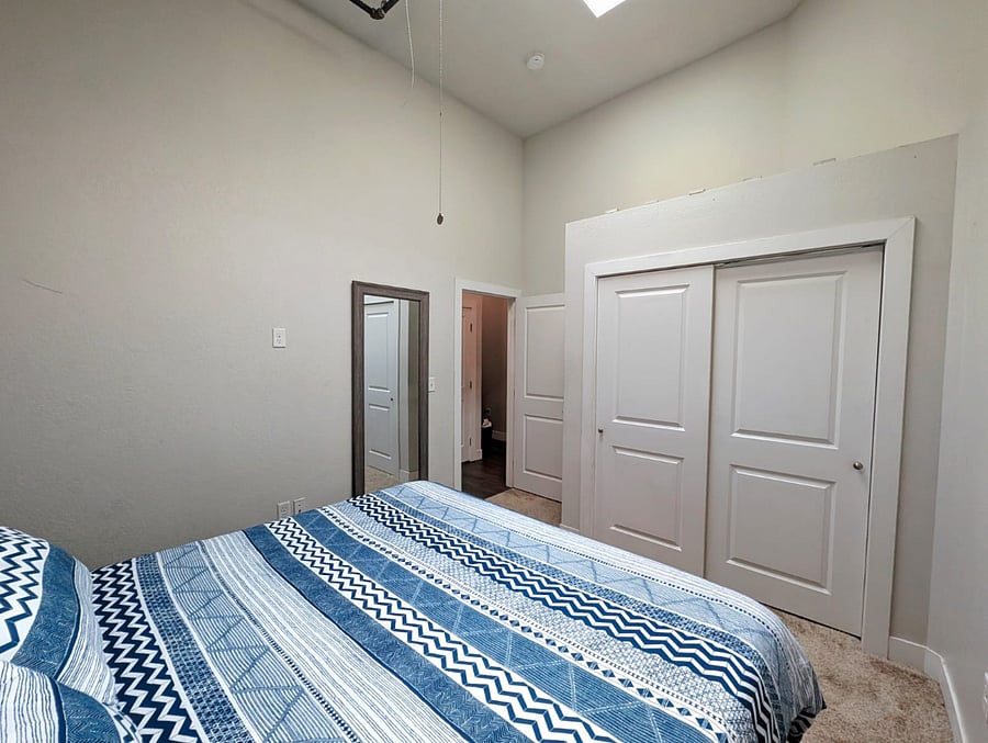 Spacious king-size bed with plush bedding, inviting a comfortable nights sleep