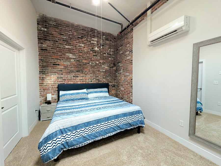 Spacious king-size bed with plush bedding, inviting a comfortable nights sleep