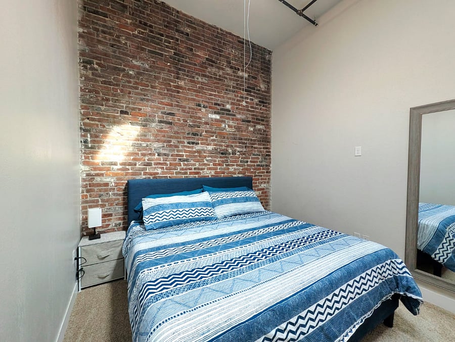 Spacious king-size bed with plush bedding, inviting a comfortable nights sleep