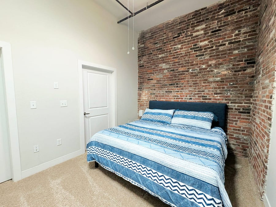 Spacious king-size bed with plush bedding, inviting a comfortable nights sleep