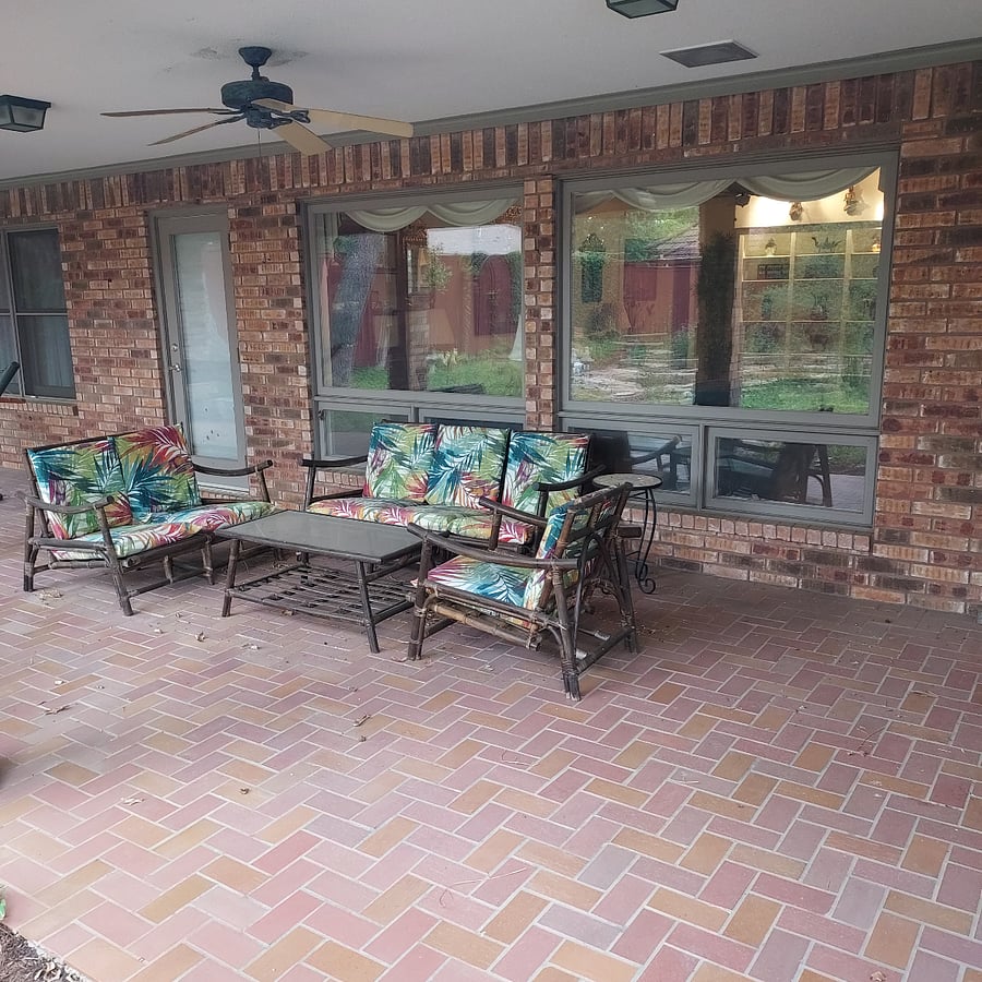 Back covered porch with outdoor lighting and ceiling fans, facing pool and garden