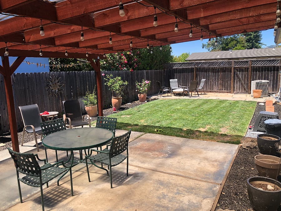 Backyard: covered patio, bbq, lawn and fire pit.