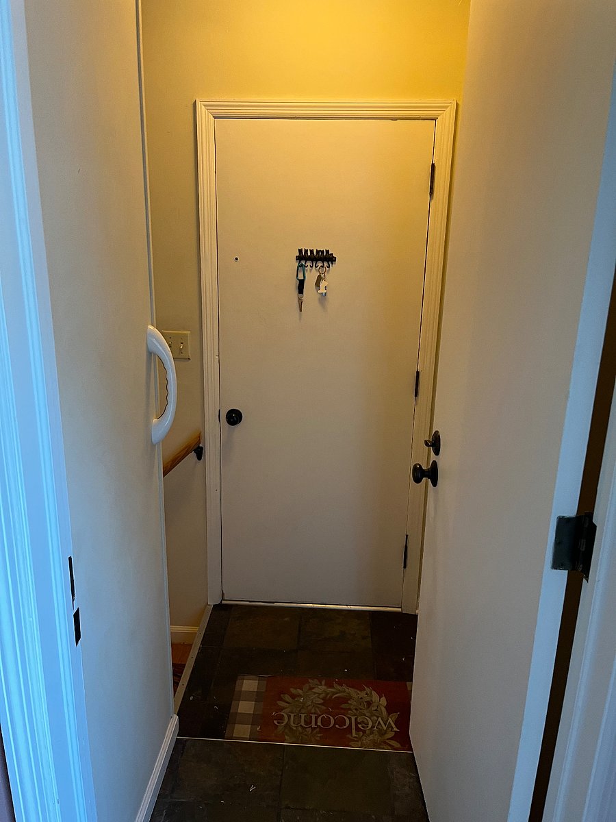 This doorway leads from the patio room/kitchen area directly to the garage. Between the two doorways is the stairwell to the left that leads down to the rental area. The entry door into the Florida room/kitchen area can be closed for additional privacy. I only need access to get to the garage (or laundry in the basement).