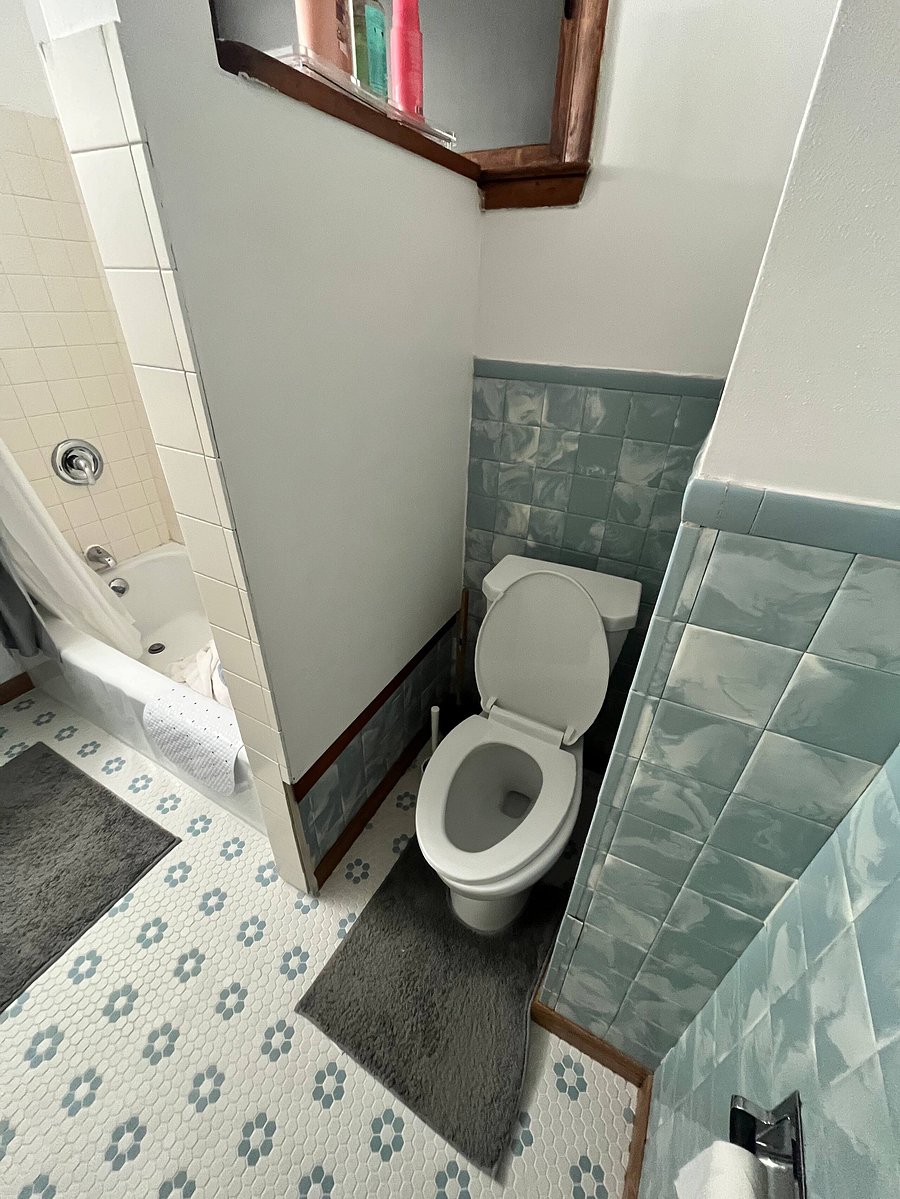Original wall tile - in vogue for 1950's! Brand new, pristine floor tile and toilet.