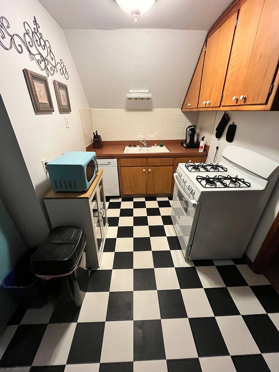 light over the sink is from the '50's; in-cabinet dishwasher; blue microwave to match the fridge; 4 burner gas stove with oven; Keurig; assortment of knives housed in a knife block