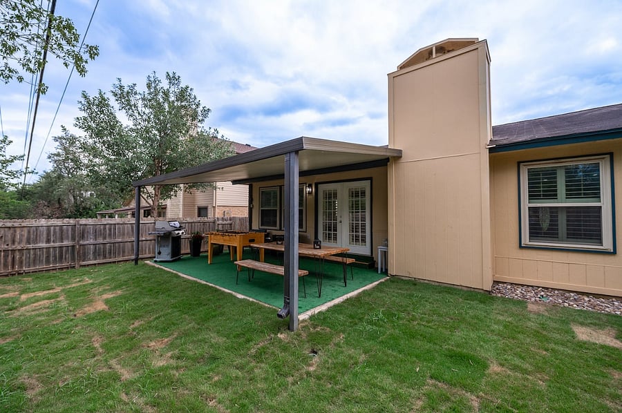 Grill, dine, and unwind in this spacious covered patio with seating for 8+ and plenty of room to relax.