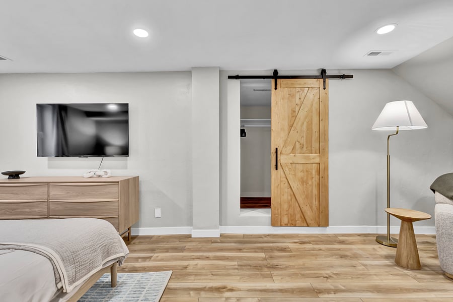 Another view of the king bedroom. Cute barn door & Roku TV.