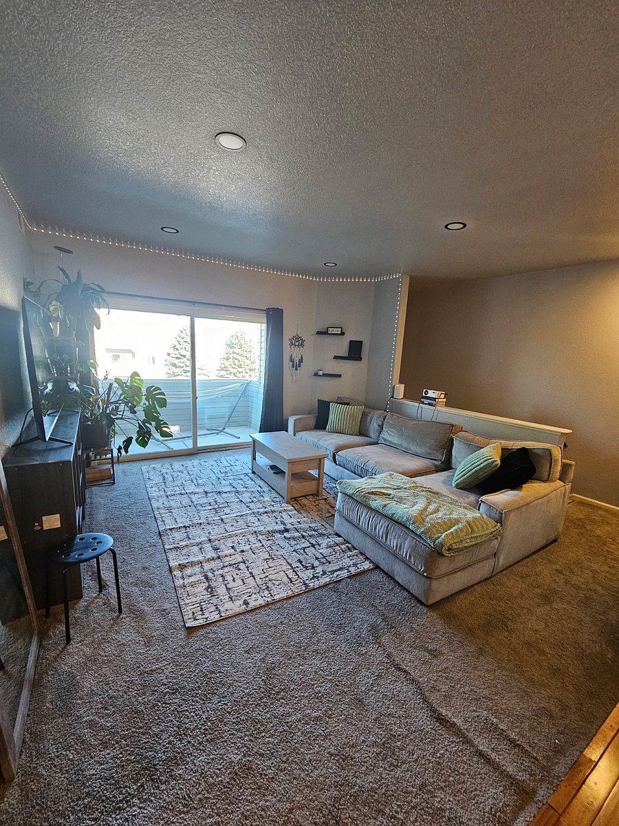 Living room with curtains open showing the large private balcony