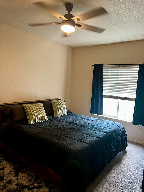 Master bedroom with a king size bed. Headboard has plug ins to charge your phone