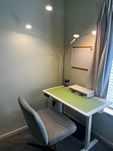 Work area with a whiteboard and standing desk in the second bedroom