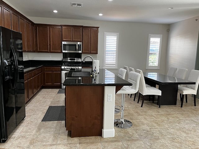 Spacious kitchen  island seating and 68 person dining table