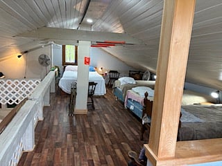 Loft area set up in dorm style with Reading - Nap & Chill Zone in the upper left hand corner.