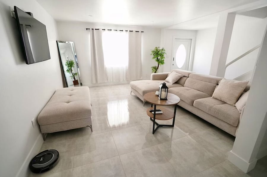A warm and inviting living room styled with minimalist and tropical elements.