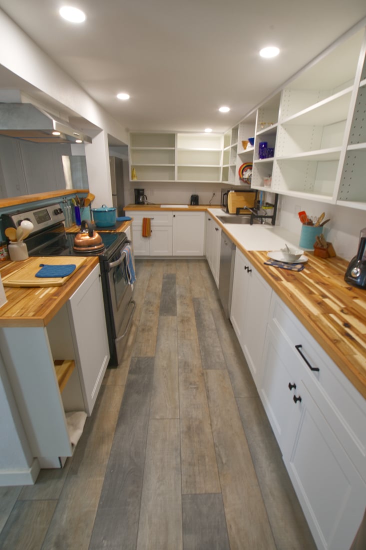 Kitchen counters are oiled butcher block and there's lots of open shelving for your pantry items.