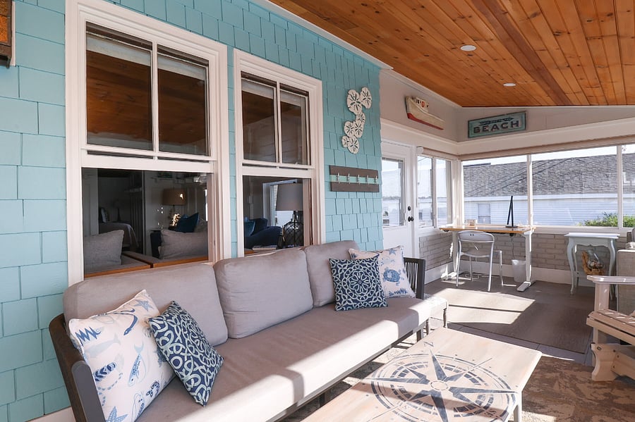 Front porch (4-season) sofa and adjustable-height desk overlooking ocean