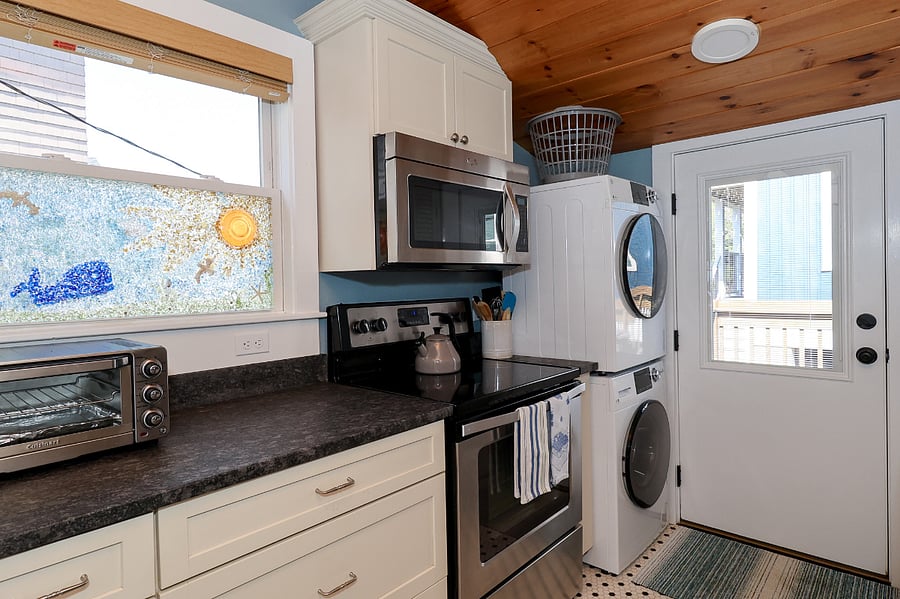 full-stocked kitchen with washer and dryer