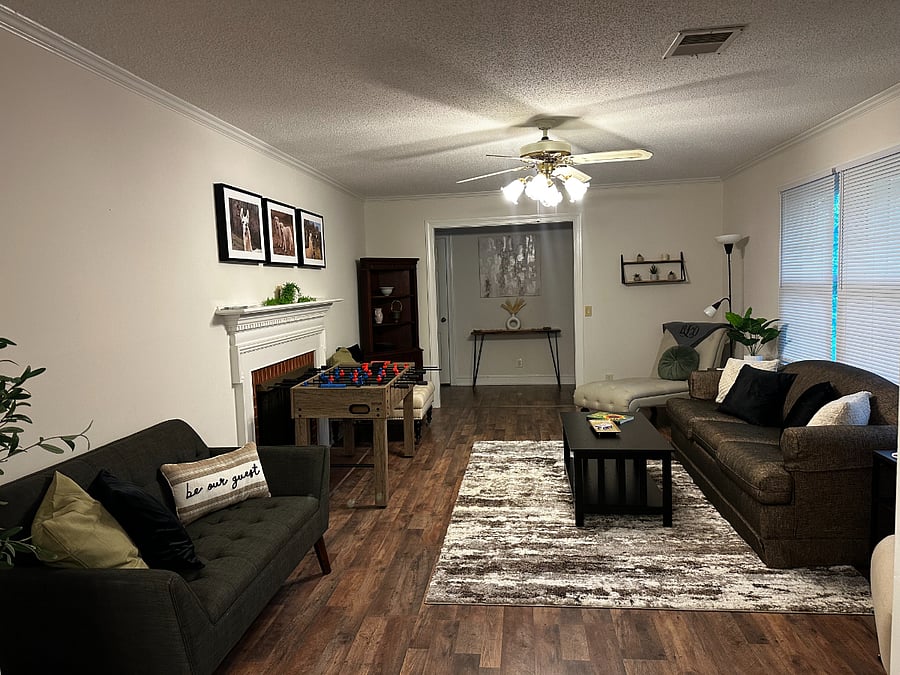 Living room with gas logs.  There is a foosball table sitting in this room temporarily as we will be adding a game room in the future.  