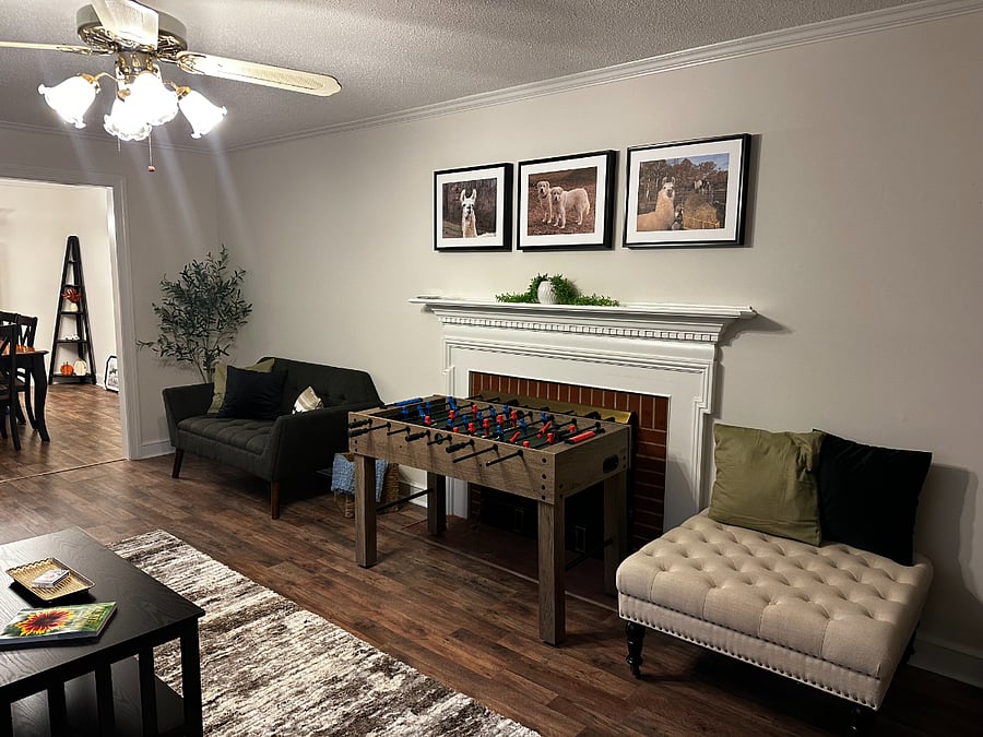 Living Room featuring the foosball table and another seating area. 