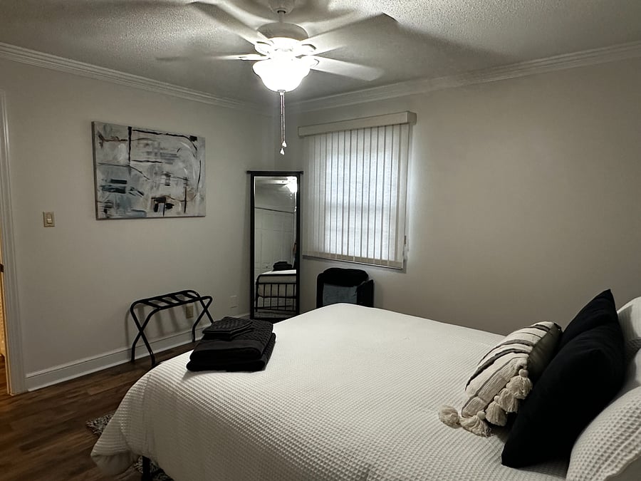 Bedroom 2 featuring another full size mirror.  Each room has a luggage rack for guests as well. 
