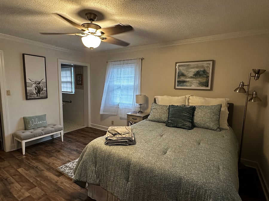 Entrance of the master bathroom is viewable in this image.