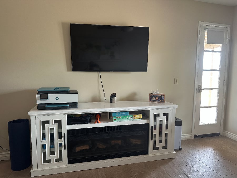 Flatscreen TV with cozy electric fireplace