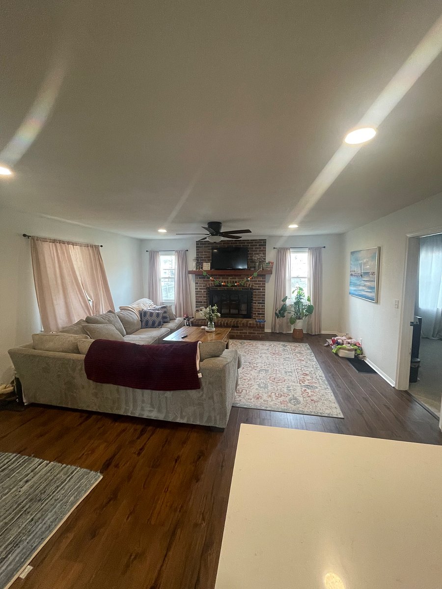 Shared living room with TV and non-working fireplace. 