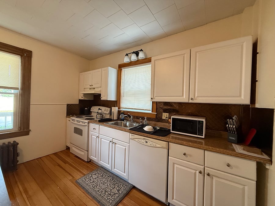 Fully equipped kitchen with stove and microwave
