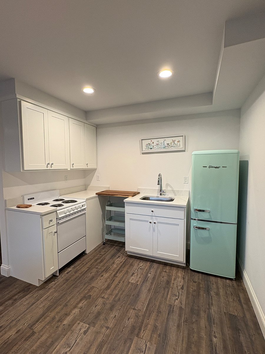 Kitchen boasts a new "old school" mint fridge and apartment size electric range.