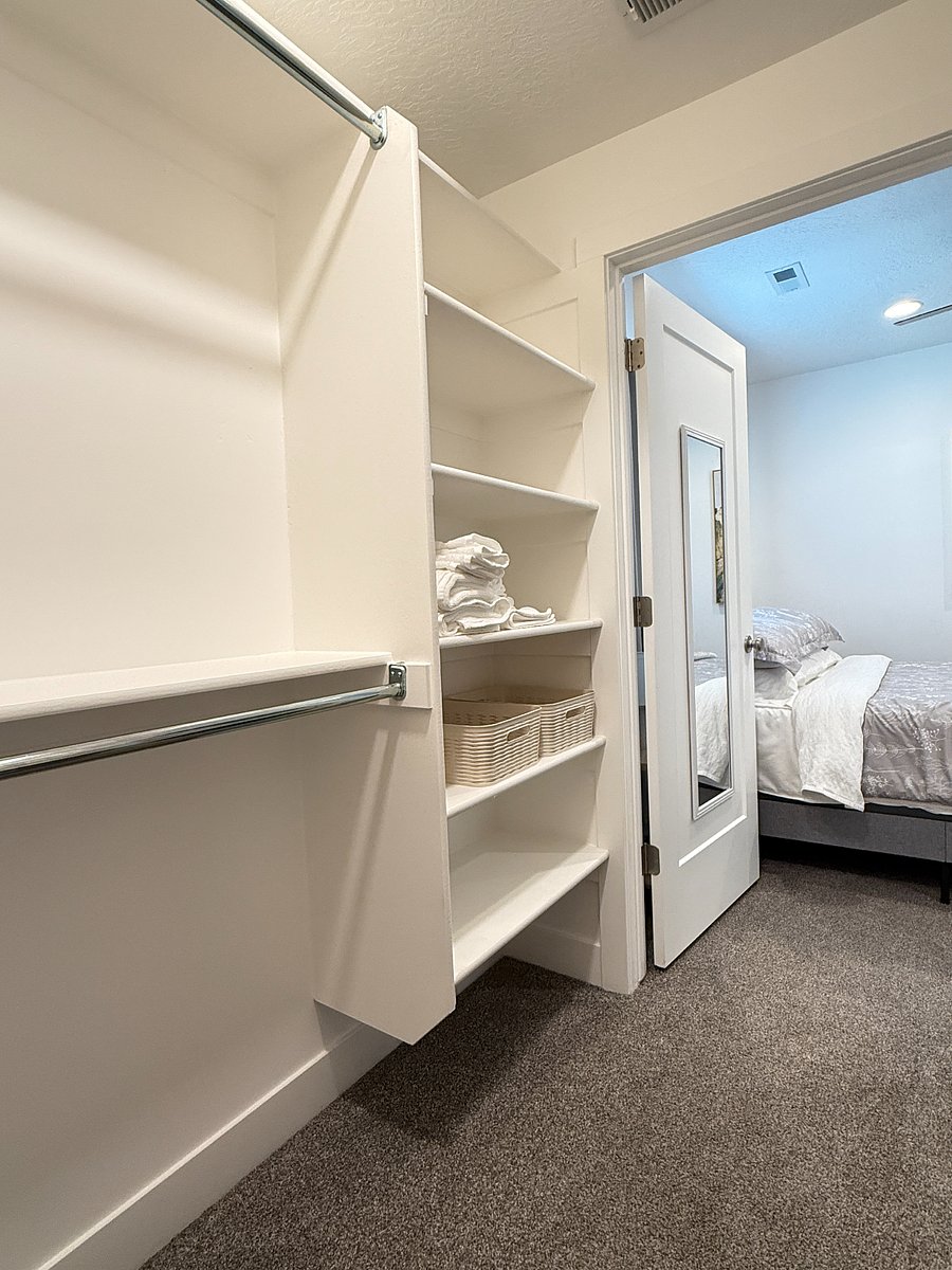 Spacious walk-in bedroom closet with ample shelving and hanging space for all your storage needs