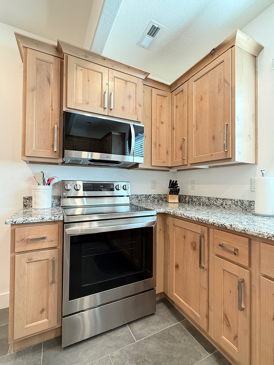 Kitchen features a full size fridge, oven, and microwave