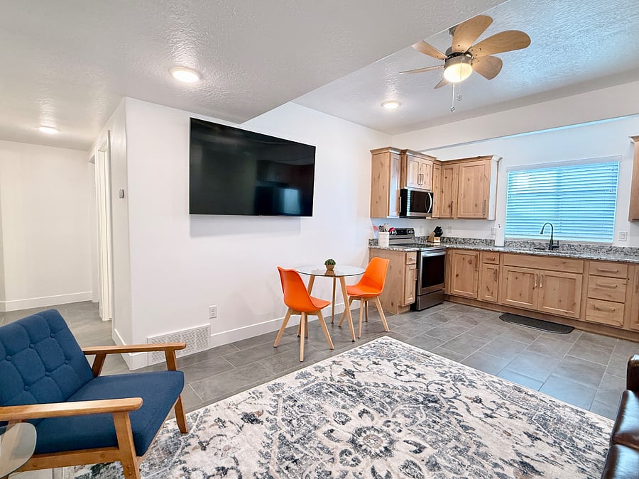 Living and dining area with a clear view of the hallway leading to the bedroom, bathroom, and laundry area