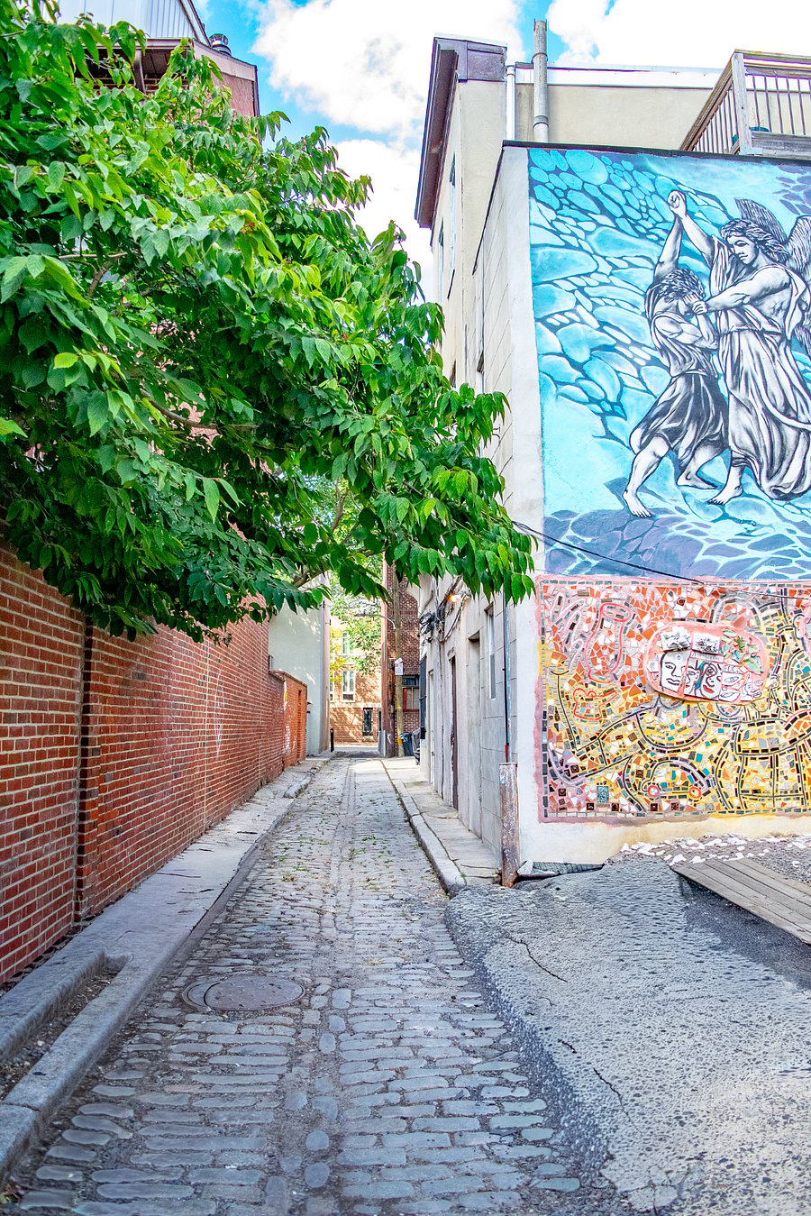 Located on a charming historic cobblestone street with colorful mural 
