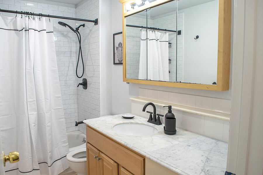 Bathroom with newly retiled shower and updated fixtures