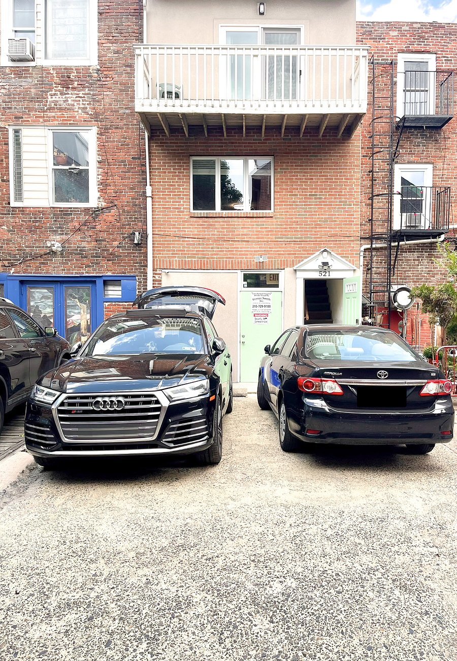 Designated parking space for unit one is shown where black SUV is parked.