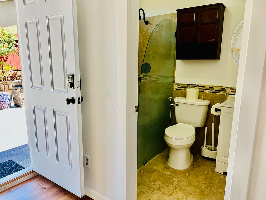Your journey begins at the main entrance, secured with a modern, keyless digital lock that ensures your peace of mind from the moment you arrive.
Inside, the bathroom door is a solid, standard door that offers complete privacy. 