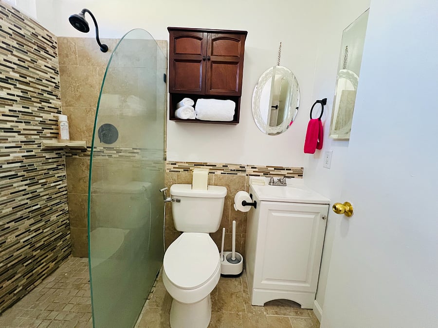 The bathroom is a clean and fully functional space that features a standard toilet, a full-size shower with good water pressure. The vanity provides a modest sink with faucet and medicine cabinets on the wall that offer convenient, discreet storage for your personal items. It includes a basic first aid kit. 