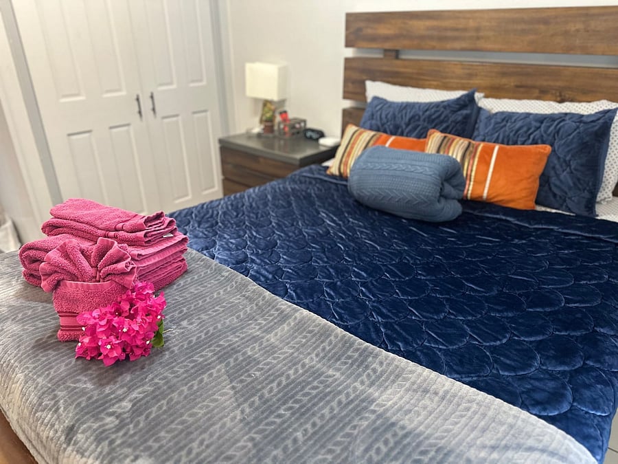 Large bedroom for your travel group with extra linens, towels, storage, TV entertainment, and large mirror. Sleeps two persons