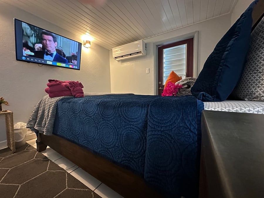 Master bedroom with additional entrance, TV entertainment, large mirror, extra linens, towels, queen bed, and a rollaway bed. Sleeps three persons