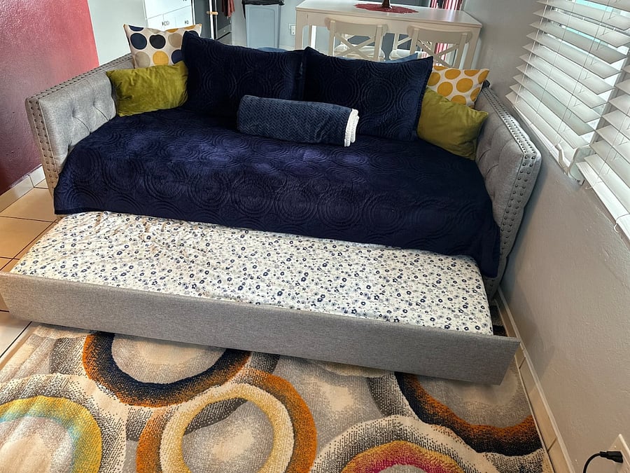 Extra sleeping for two guests in living area. Daybed and trundle are single beds with additional linens available