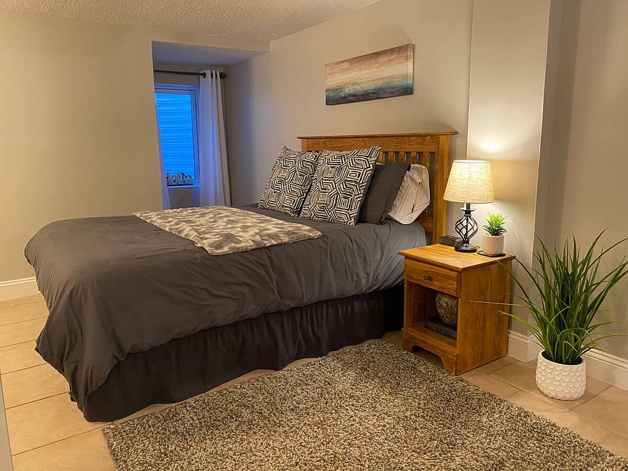 Comfy bed in master bedroom has a queen mattress and down alternative comforter. Mattress and box springs are encased in premium protective covers. This bedroom has one large walk-in closet and one small closet.