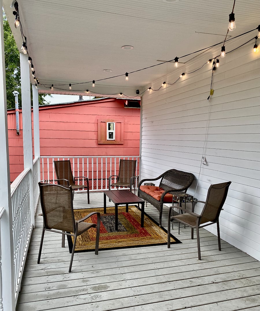 Large spacious, covered back patio with Bistro lights and ample seating for your comfort and enjoyment.