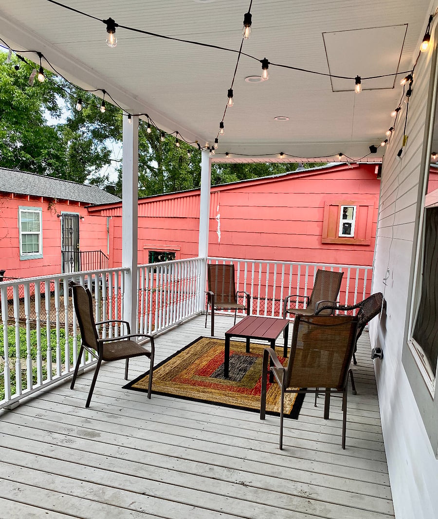 Large spacious, covered back patio with Bistro lights and ample seating for your comfort and enjoyment.