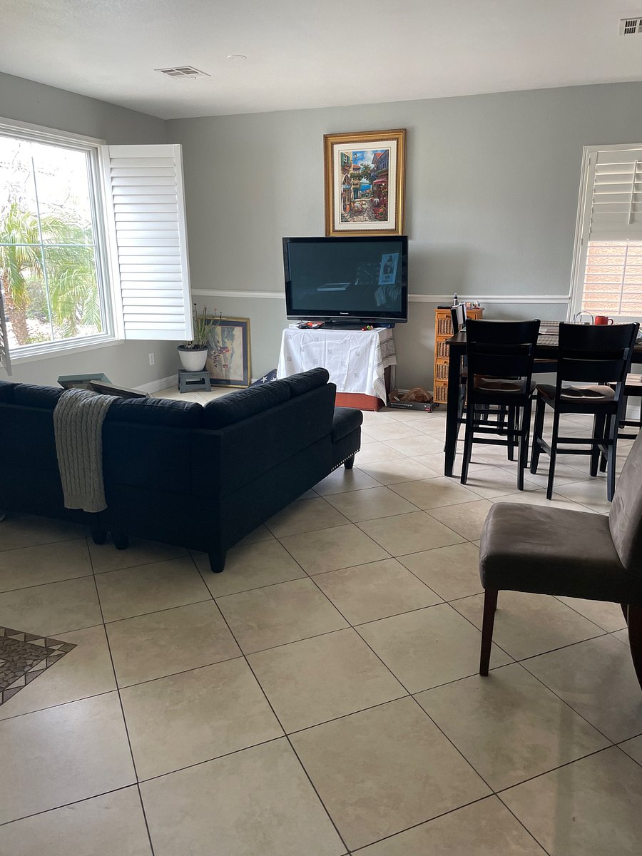 View of living room and dining room and front entrance, along with picture window in  living room. This large plasma TV has a smart (fire stick TV) to make it smart for access to prime video, Netflix, and Internet with Wi-Fi.